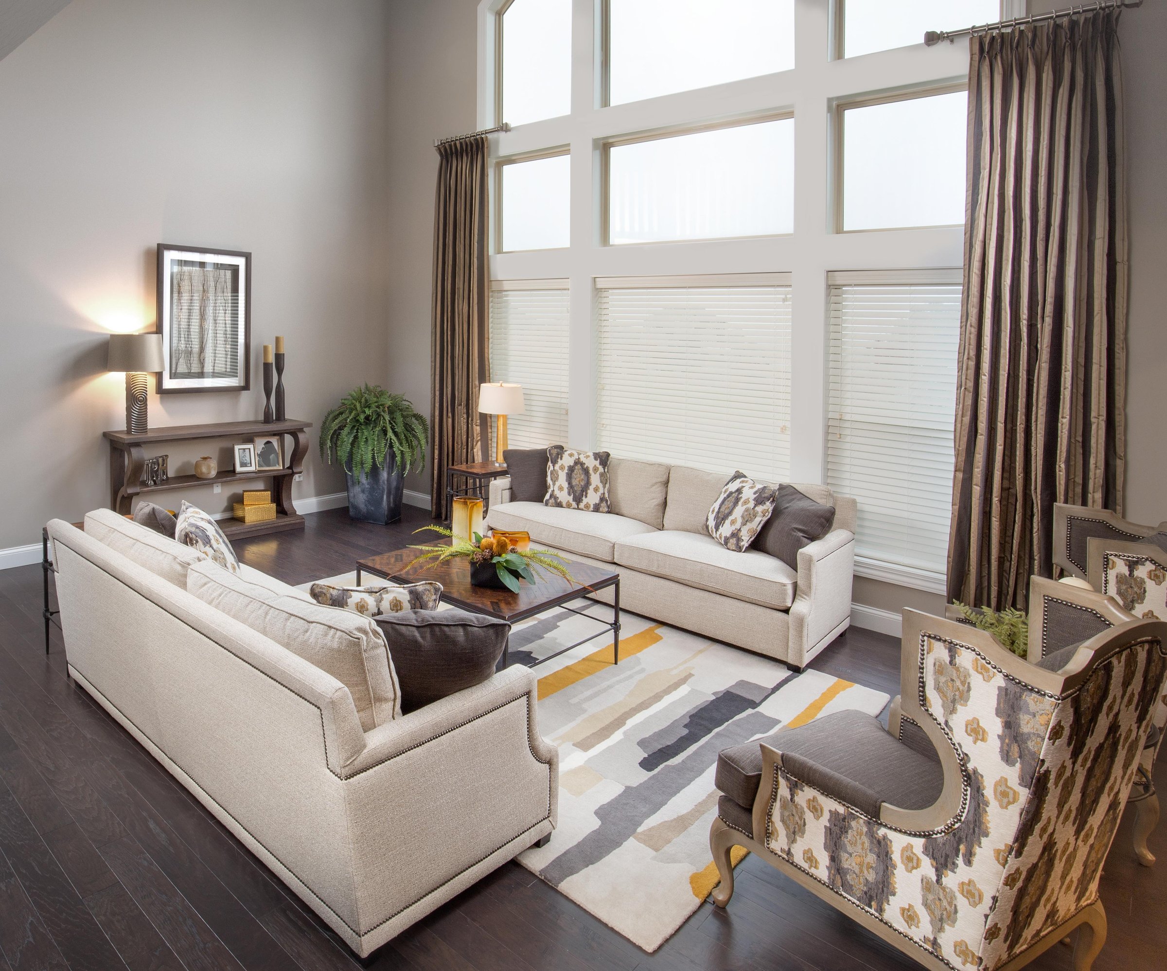 Mary Shipley Interiors hero photo — a sunlit living room with floor-to-ceiling windows and tailored drapery